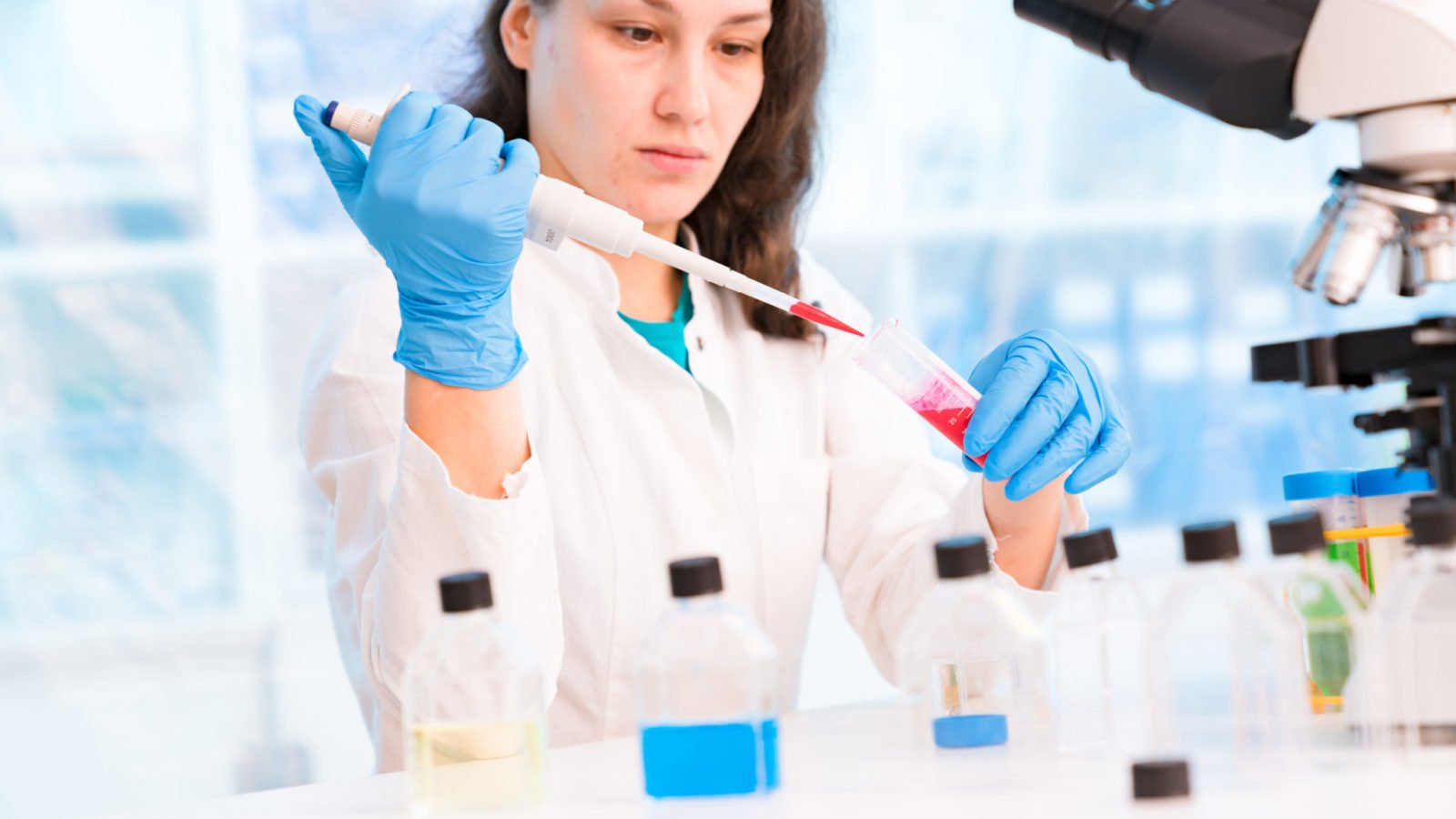 photo of woman working in lab performing tests for the genetics of cancer