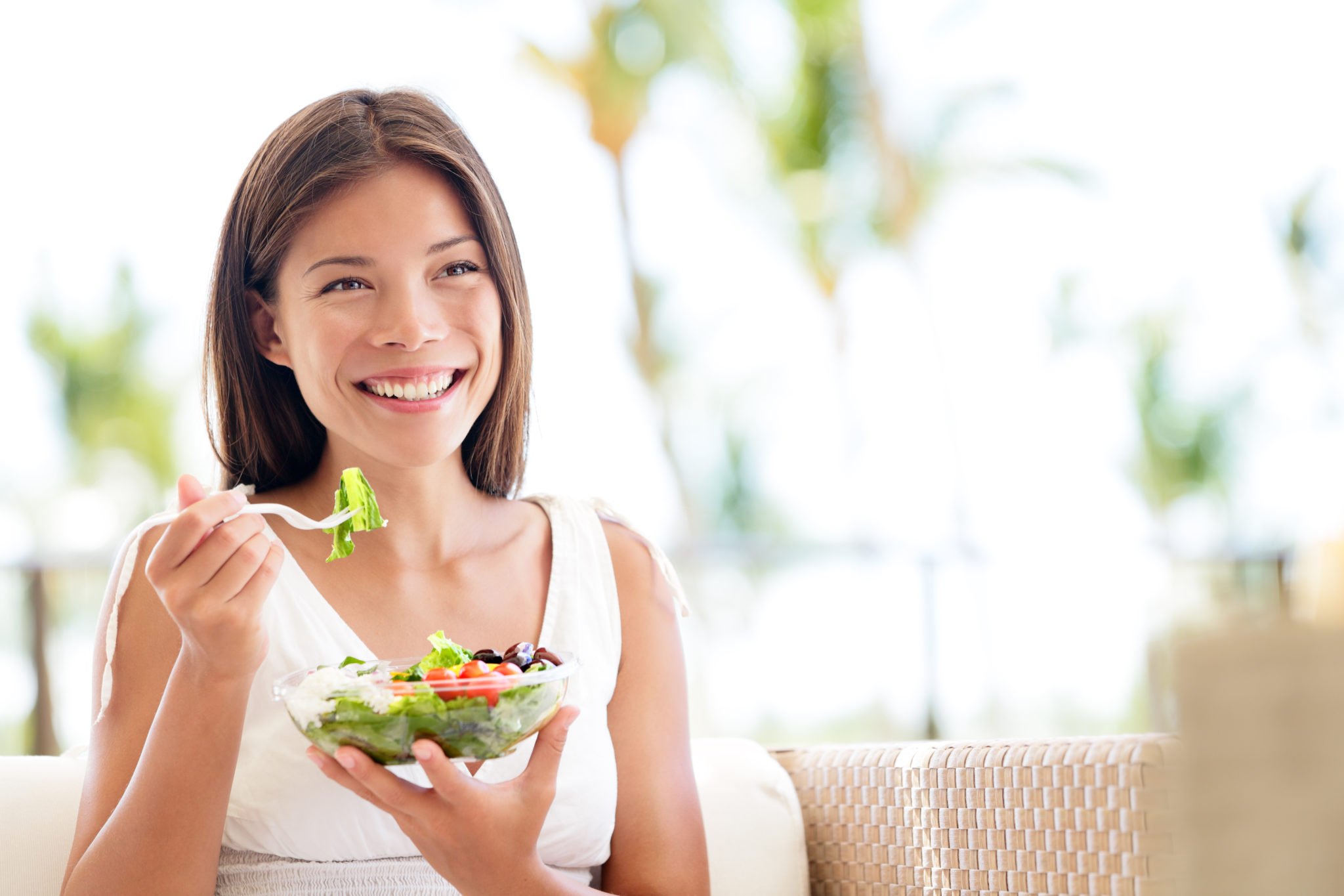 photo of woman eating a salad, good nutrition for gene expression