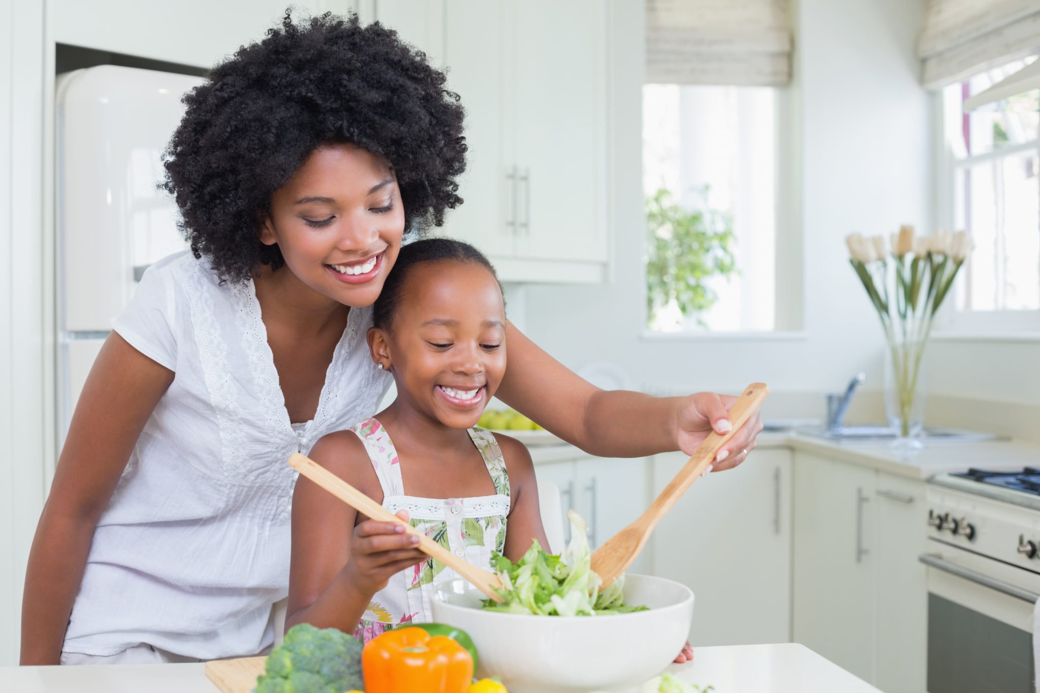 photo of mother and daughter preparing healthy food